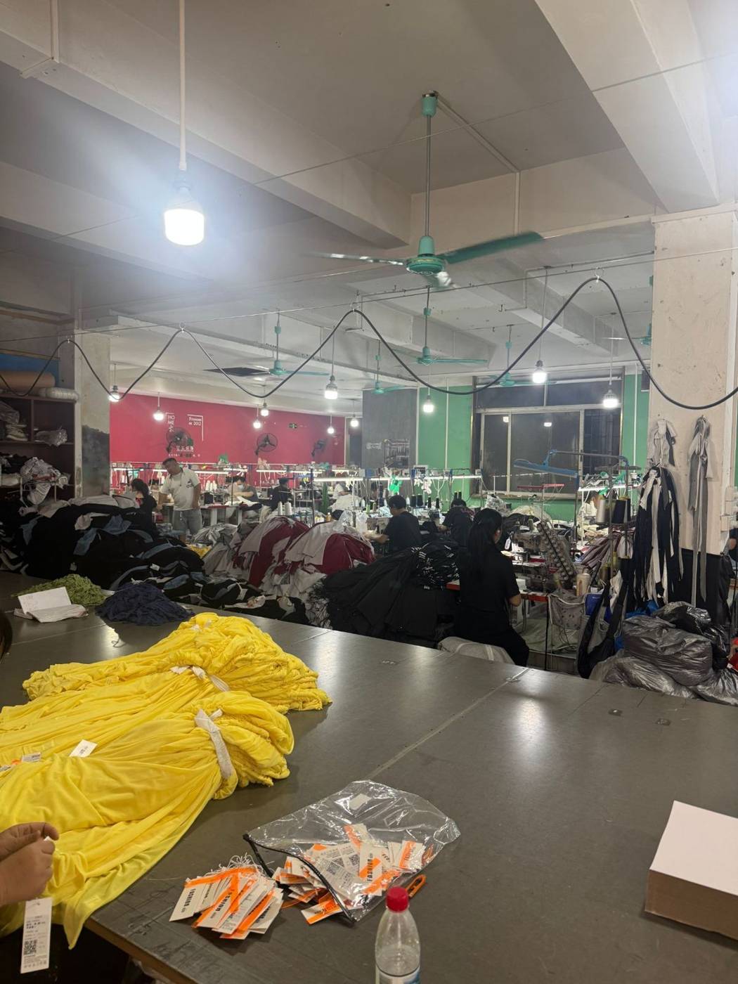 Sewing workshop with stacks of garments